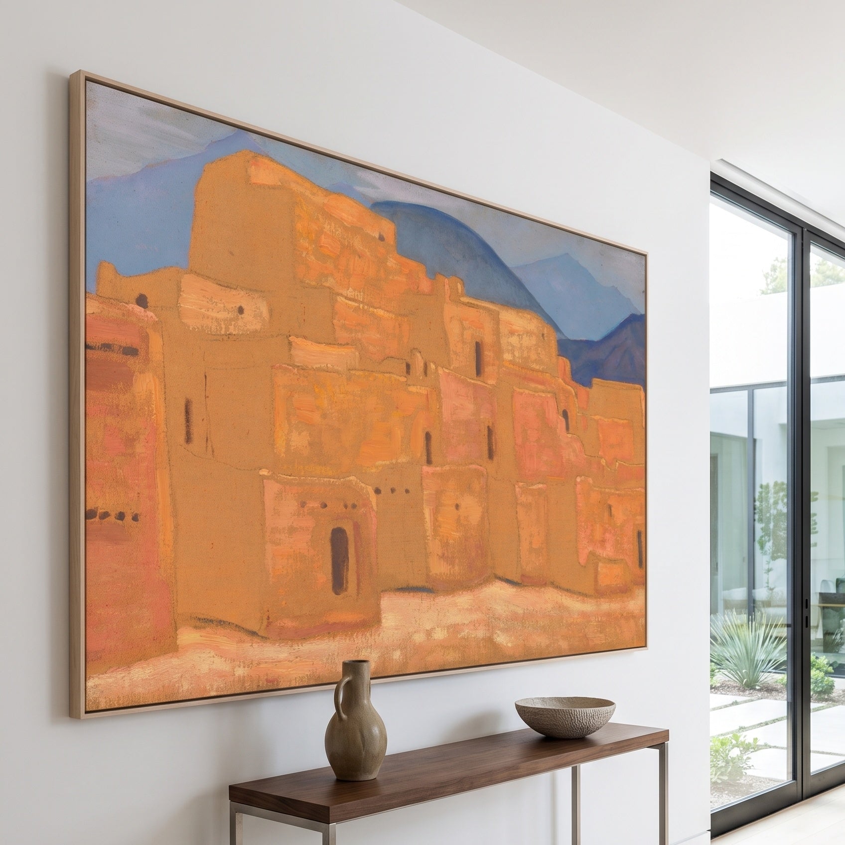 Taos Pueblo, New Mexico by Nicholas Roerich — large orange and blue Symbolist canvas art on a hallway wall