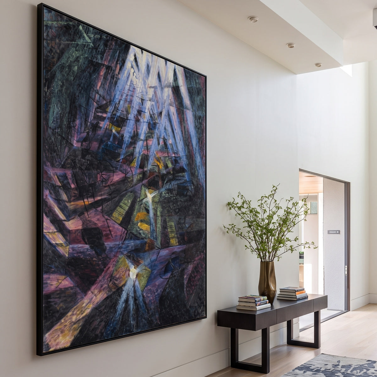The Forces of a Street by Umberto Boccioni — large purple and black Futurist canvas art on a entryway wall