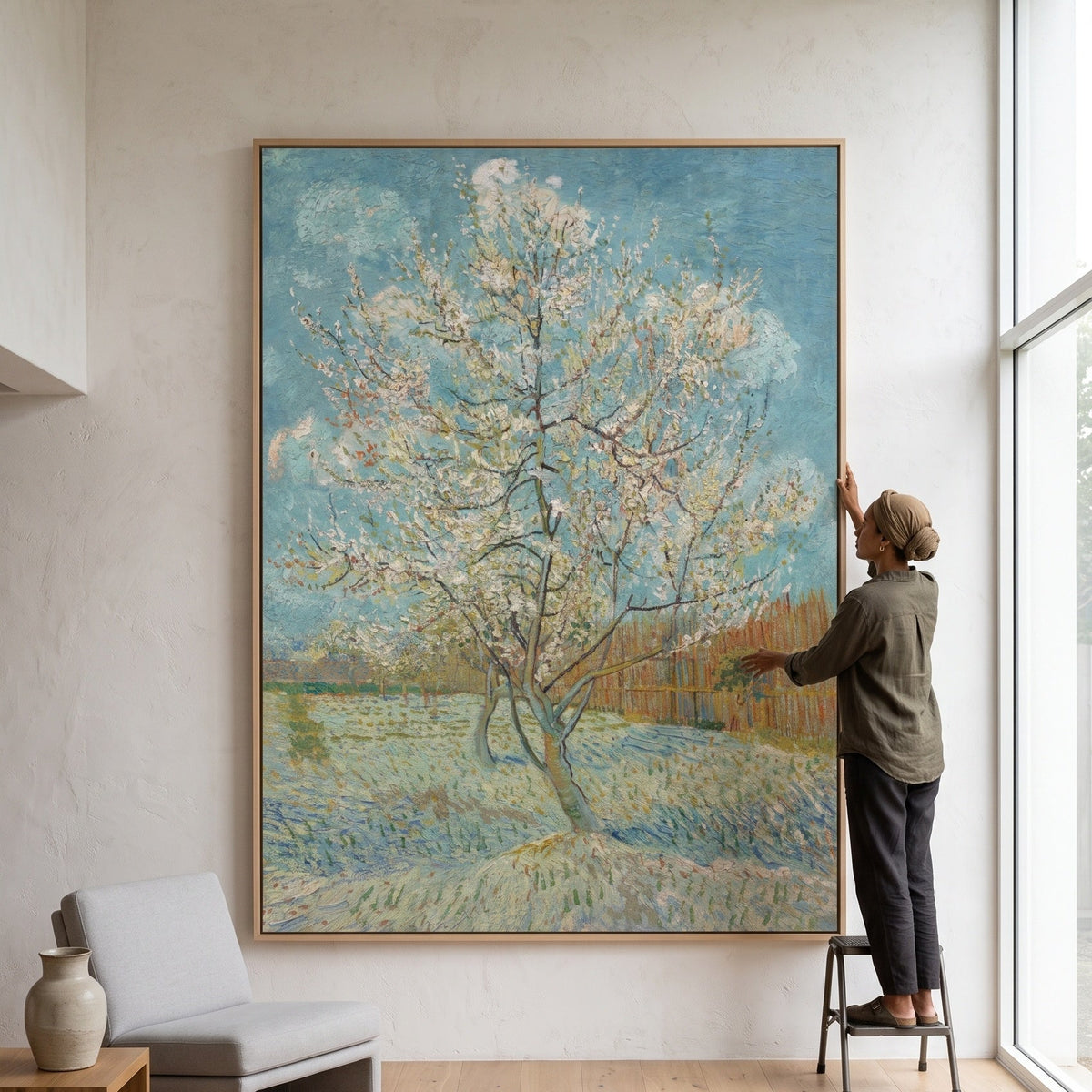 The Pink Peach Tree by Vincent van Gogh — large light blue and green Impressionist canvas art on a living room wall