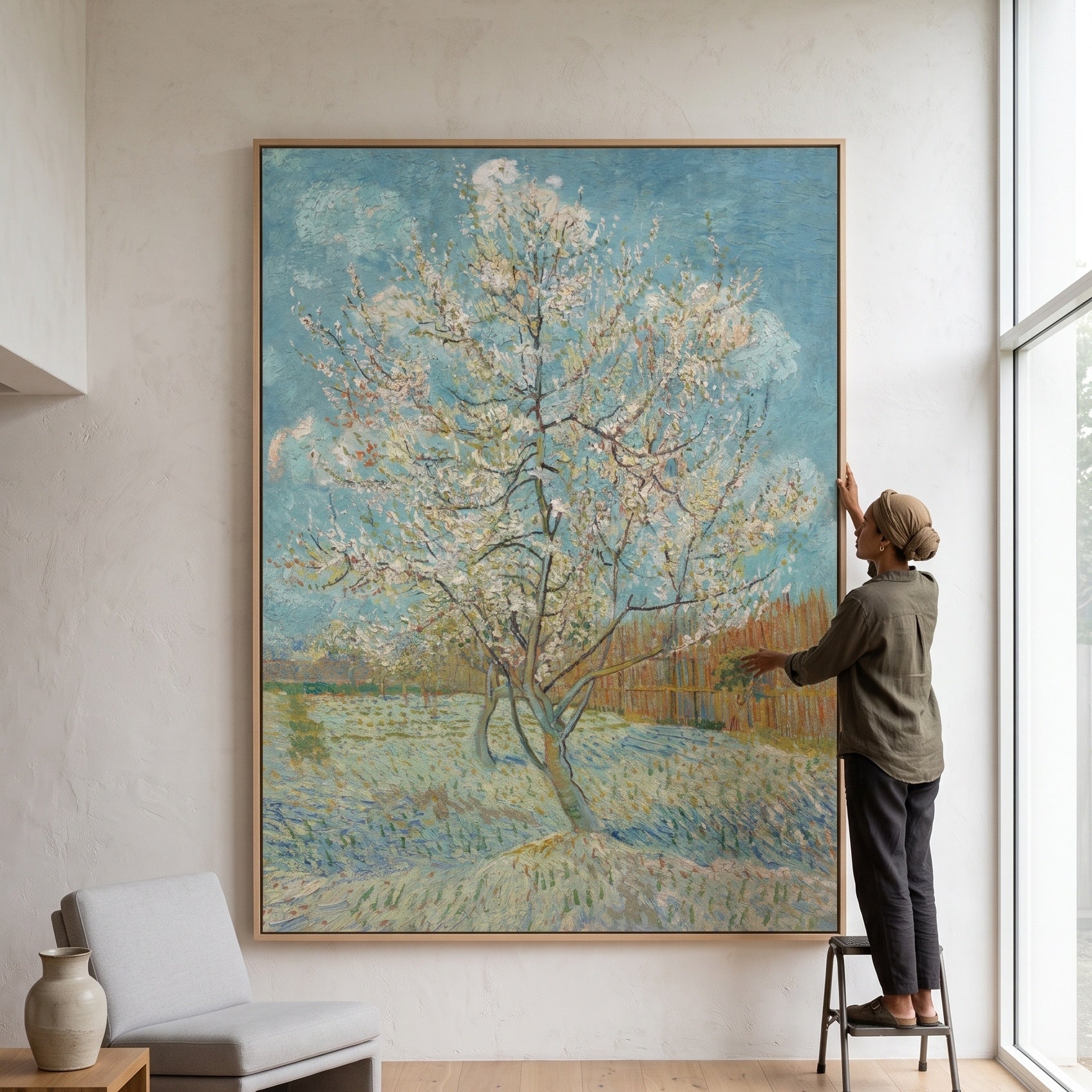 The Pink Peach Tree by Vincent van Gogh — large light blue and green Impressionist canvas art on a living room wall