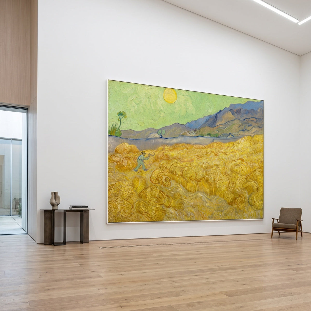 Wheatfield with a Reaper by Vincent van Gogh — large gold and green Impressionist canvas art on a hallway wall