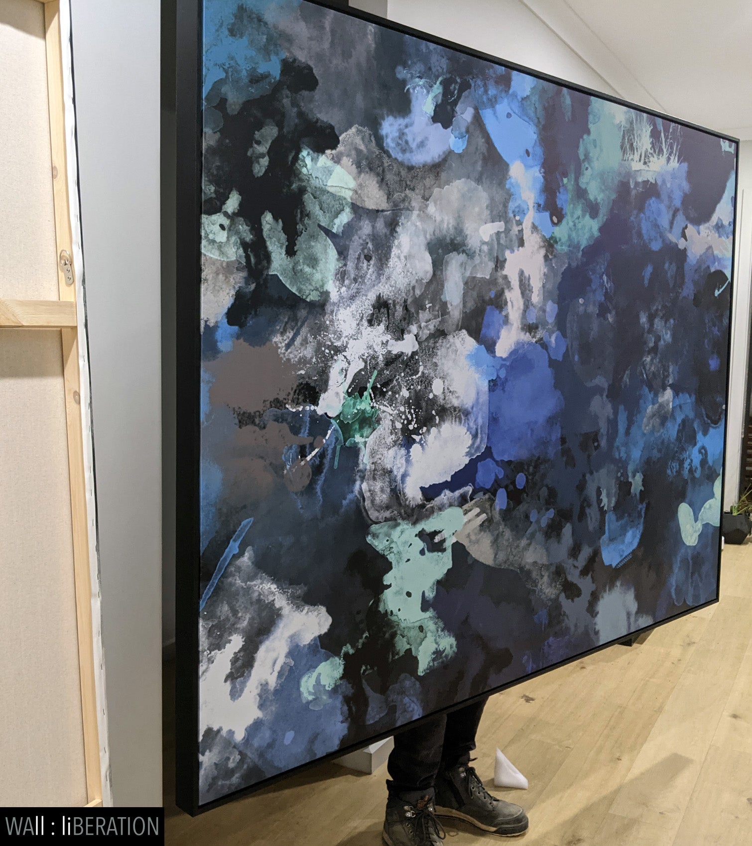 Blue World Large Scale Abstract canvas wall art framed and hung on a wall